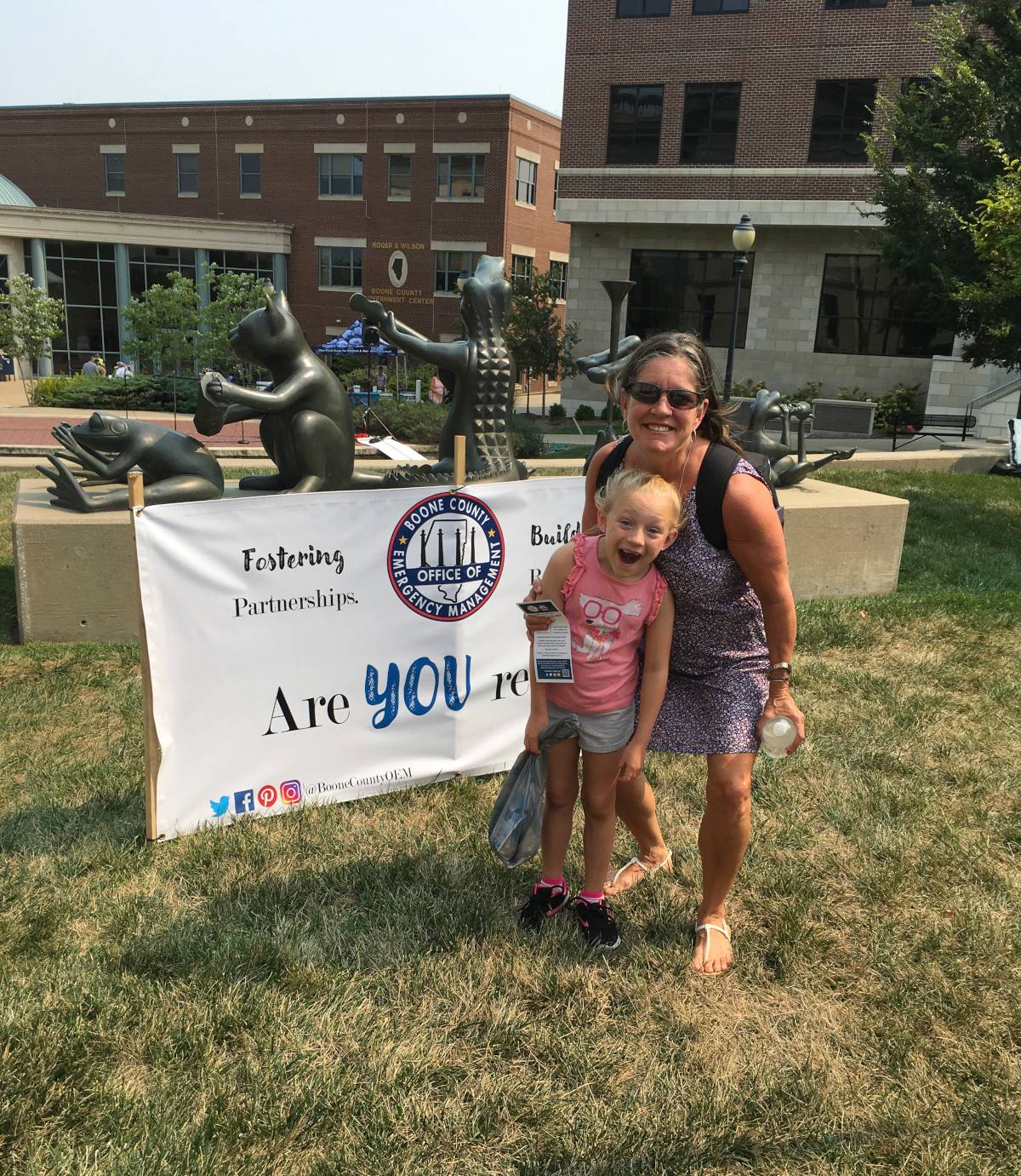 Gina Chitwood and Brea Wichern pose for a photo in front of the BCOEM branding banner during the 1st annual Preparedness Fair.
